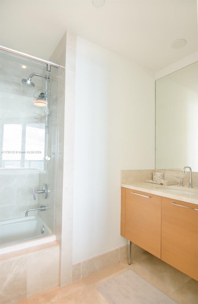 bathroom with tiled shower / bath combo, vanity, and tile patterned floors