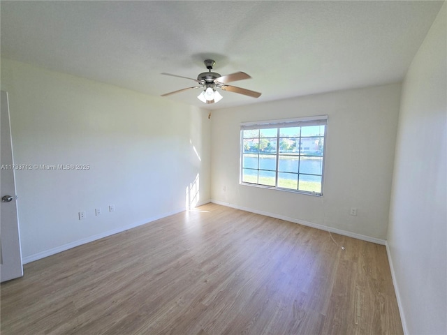 empty room featuring ceiling fan and light hardwood / wood-style floors