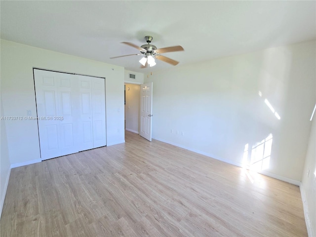 unfurnished bedroom with a closet, ceiling fan, and light wood-type flooring