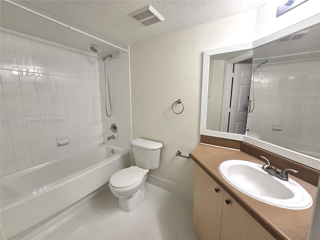 full bathroom featuring tile patterned flooring, vanity, a textured ceiling, tiled shower / bath, and toilet