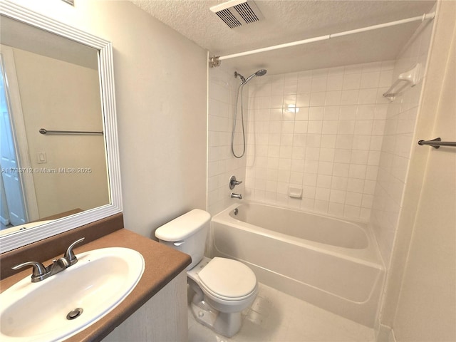 full bathroom featuring tiled shower / bath combo, vanity, a textured ceiling, and toilet