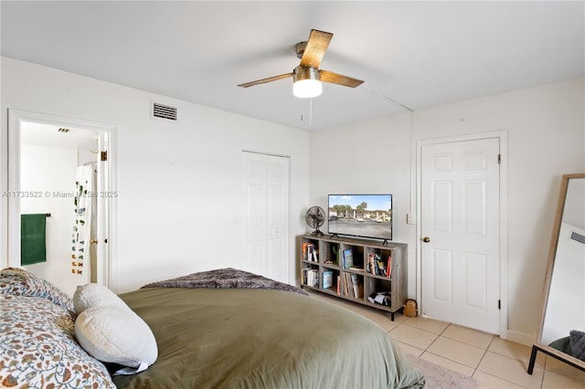 bedroom with light tile patterned floors, a closet, visible vents, and a ceiling fan