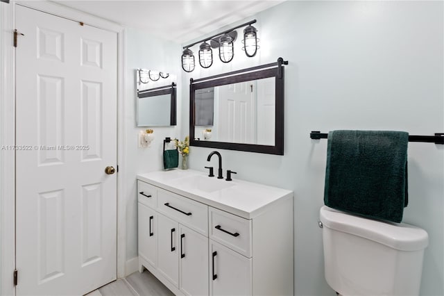 bathroom with toilet and vanity