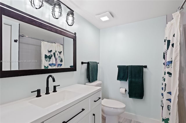 full bathroom with curtained shower, baseboards, vanity, and toilet