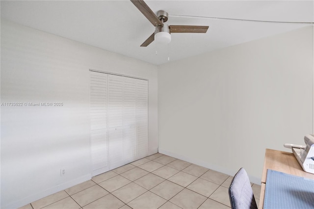 empty room featuring ceiling fan and light tile patterned floors