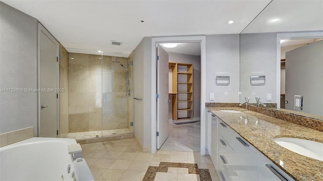 bathroom featuring tile patterned flooring, vanity, and separate shower and tub