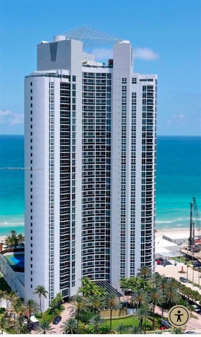 view of building exterior featuring a view of the beach and a water view