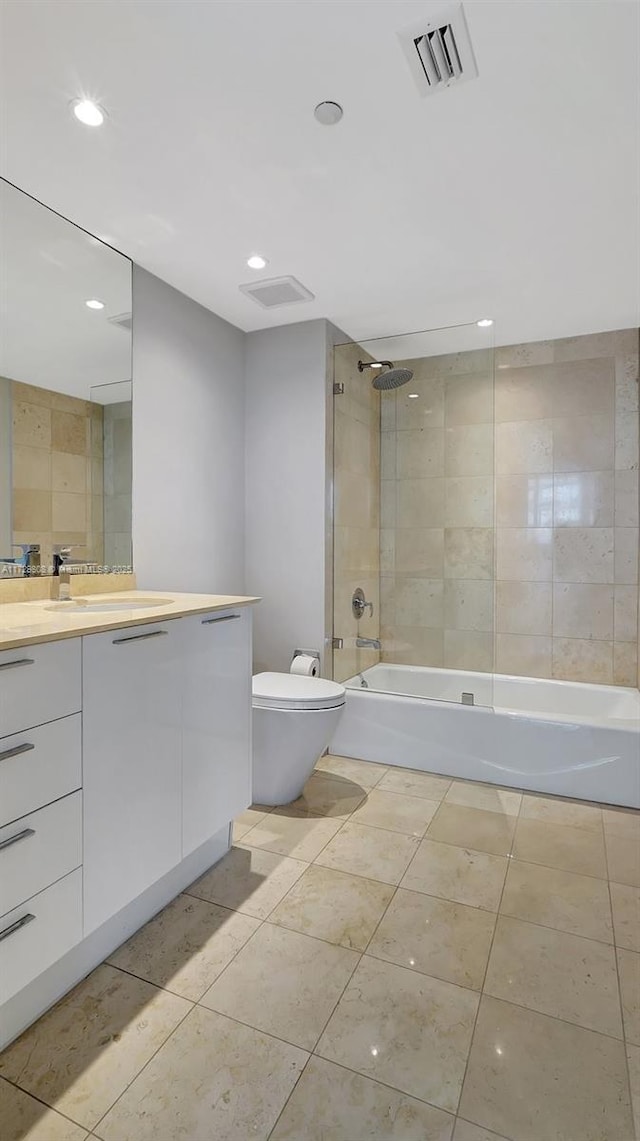 full bathroom with vanity, tile patterned flooring, toilet, and tiled shower / bath