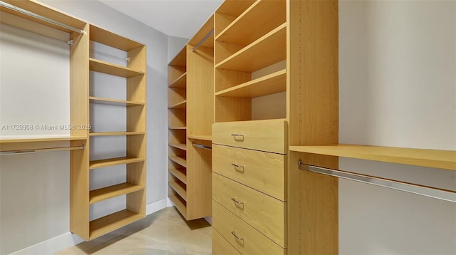 walk in closet featuring light tile patterned flooring