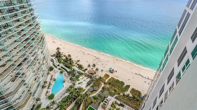 aerial view with a water view and a beach view
