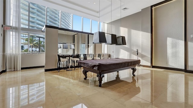 miscellaneous room featuring a tray ceiling, billiards, and a high ceiling