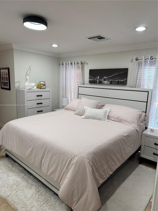 bedroom with ornamental molding and tile patterned flooring