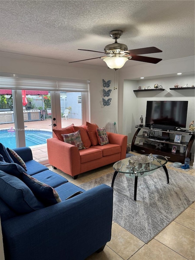 tiled living room featuring ceiling fan, a textured ceiling, and french doors