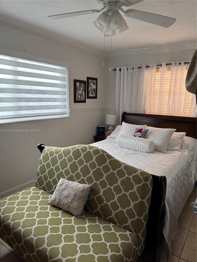 tiled bedroom with multiple windows, crown molding, a textured ceiling, and ceiling fan