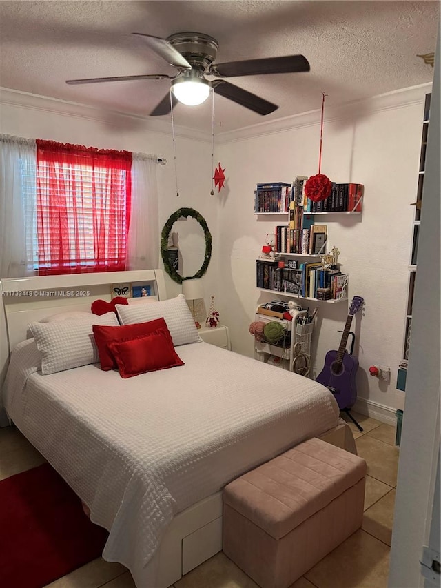 tiled bedroom with a textured ceiling, ornamental molding, and ceiling fan