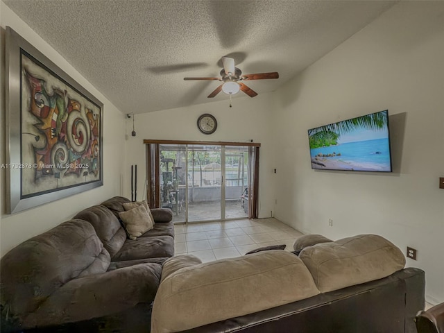 living room featuring ceiling fan, lofted ceiling, light tile patterned floors, and a textured ceiling