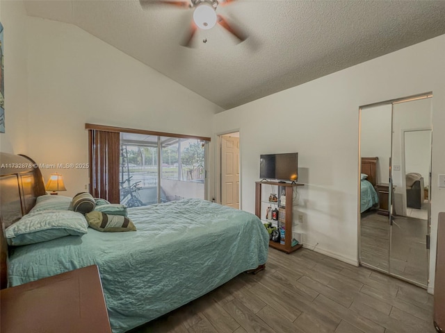 bedroom featuring hardwood / wood-style flooring, ceiling fan, vaulted ceiling, and a textured ceiling