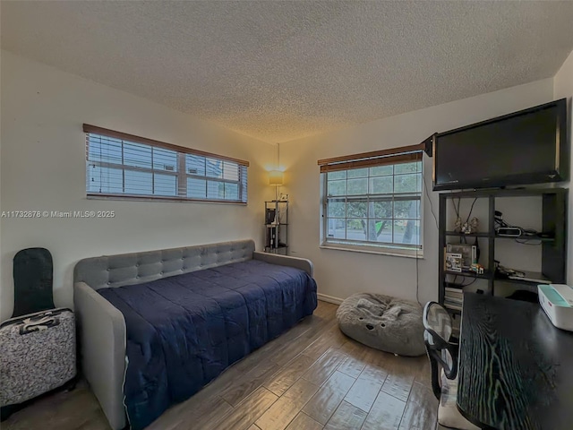 bedroom featuring light hardwood / wood-style flooring and a textured ceiling