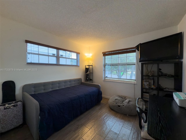 bedroom featuring hardwood / wood-style floors and a textured ceiling