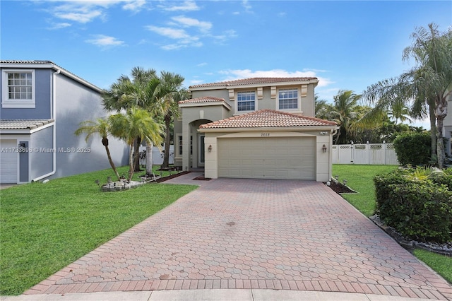 mediterranean / spanish-style home featuring a garage and a front yard