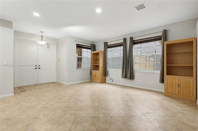 tiled spare room featuring a wealth of natural light