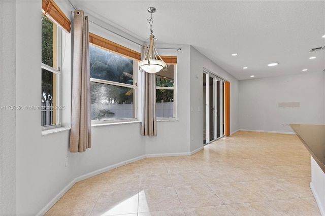 unfurnished dining area featuring light tile patterned floors