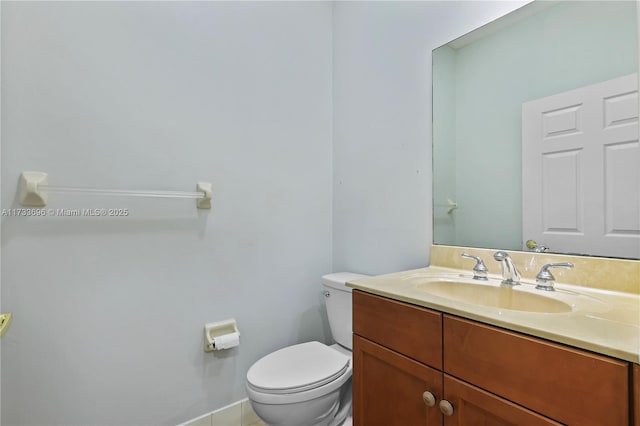 bathroom with vanity, toilet, and tile patterned flooring