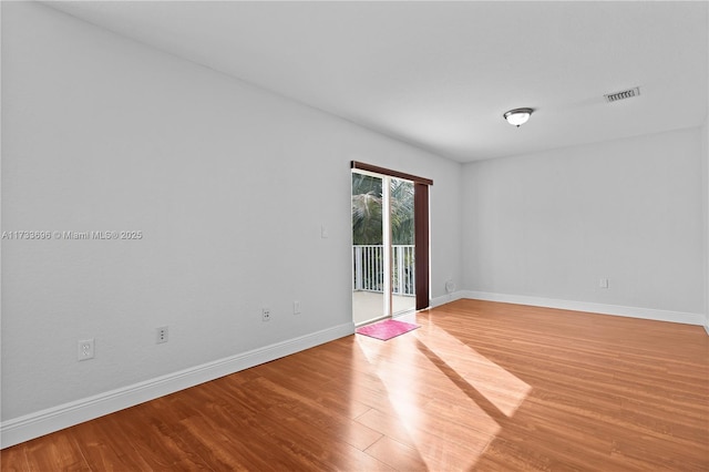 empty room with light hardwood / wood-style flooring