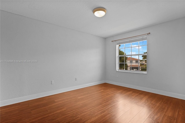 spare room featuring hardwood / wood-style floors