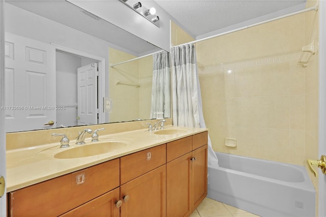 bathroom with vanity, shower / tub combo, tile patterned floors, and a textured ceiling