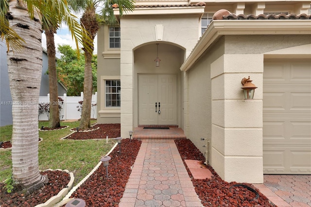 view of exterior entry with a garage