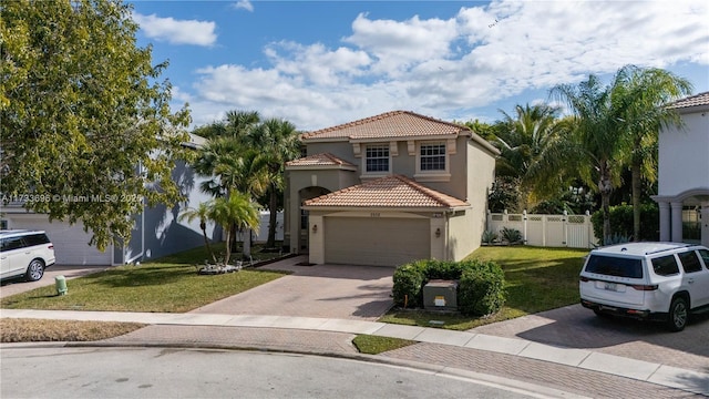 mediterranean / spanish-style house with a garage and a front yard