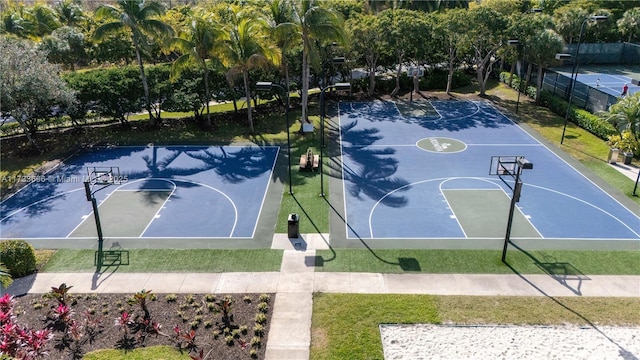 view of basketball court with a yard