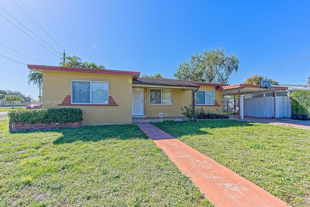 single story home featuring a carport and a front lawn