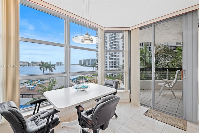 sunroom / solarium with plenty of natural light and a water view