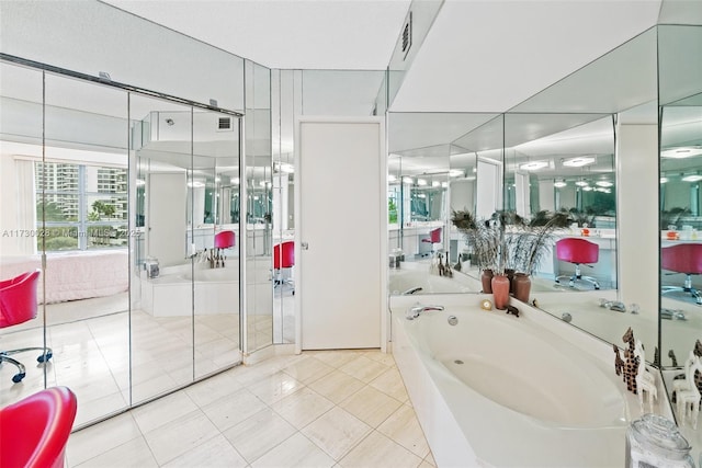 bathroom with tile patterned floors and a bathing tub