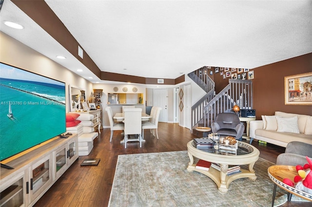 living room featuring dark hardwood / wood-style floors and a textured ceiling