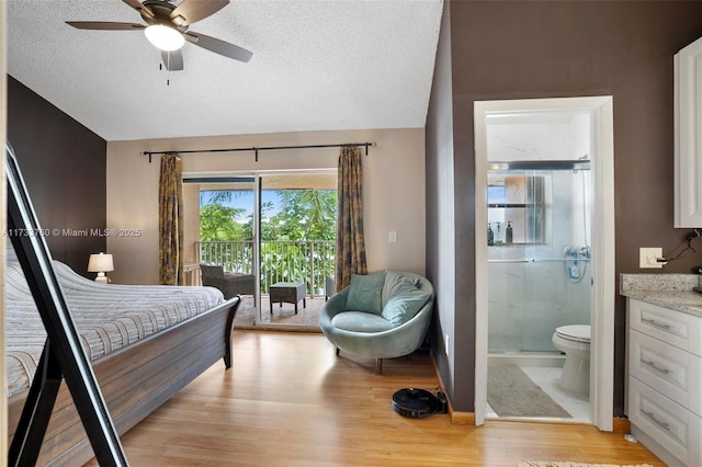 bedroom with connected bathroom, a textured ceiling, access to outside, ceiling fan, and light hardwood / wood-style floors