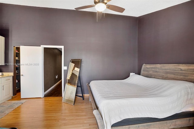 bedroom with ceiling fan and light hardwood / wood-style floors