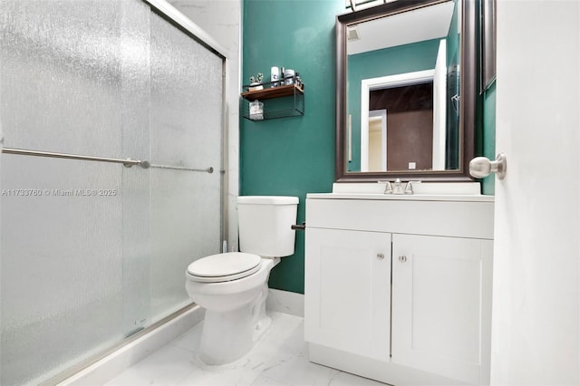 bathroom with vanity, a shower with shower door, and toilet