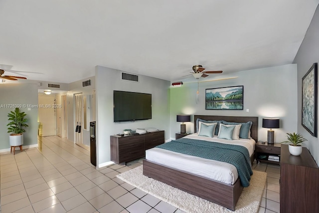 tiled bedroom featuring ceiling fan