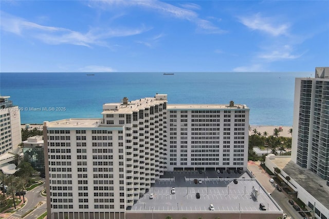 birds eye view of property featuring a water view and a beach view