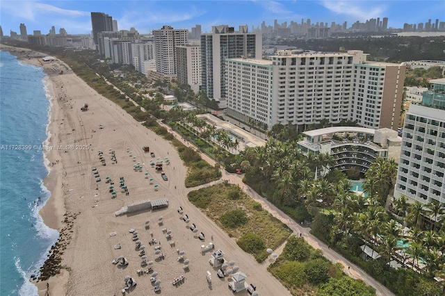 birds eye view of property featuring a beach view and a water view