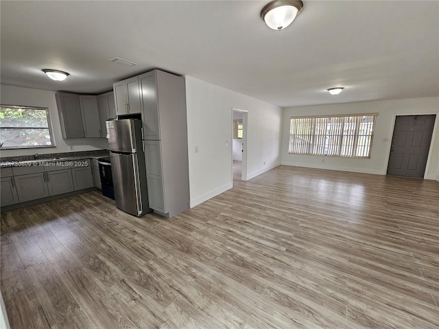 2200 N 57th Ave, Hollywood, FL 33021 - kitchen with freestanding refrigerator, gray cabinetry, open floor plan, light wood-type flooring, and baseboards