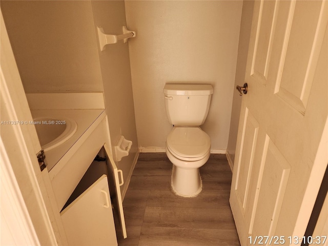 bathroom featuring hardwood / wood-style flooring, vanity, and toilet