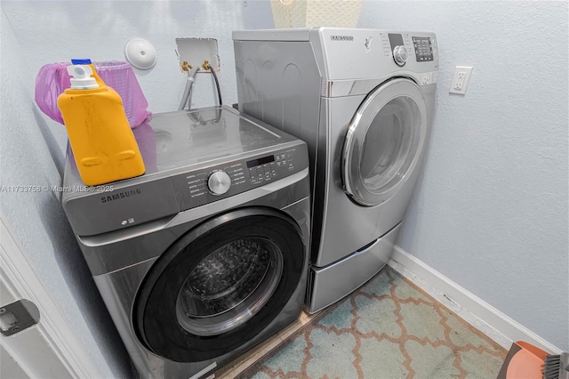 washroom featuring washing machine and dryer