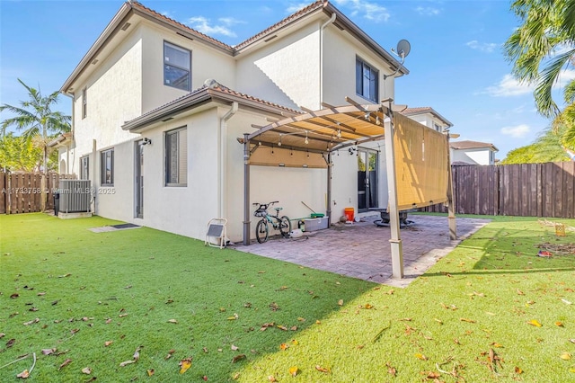 rear view of property with a pergola, a lawn, a patio, and central air condition unit