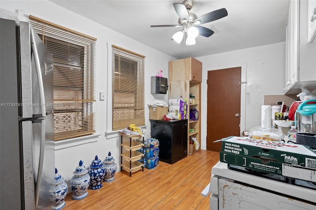 kitchen featuring stainless steel fridge, ceiling fan, and light wood-type flooring