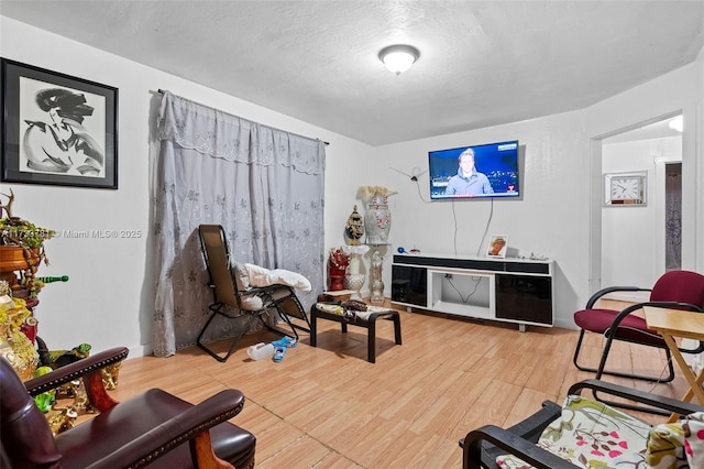 sitting room featuring hardwood / wood-style flooring and a textured ceiling