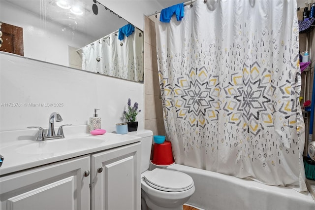 full bathroom featuring shower / bath combination with curtain, vanity, and toilet